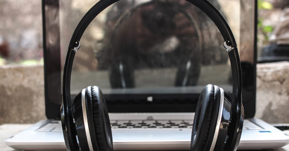 Headphone in front of laptop on a desk