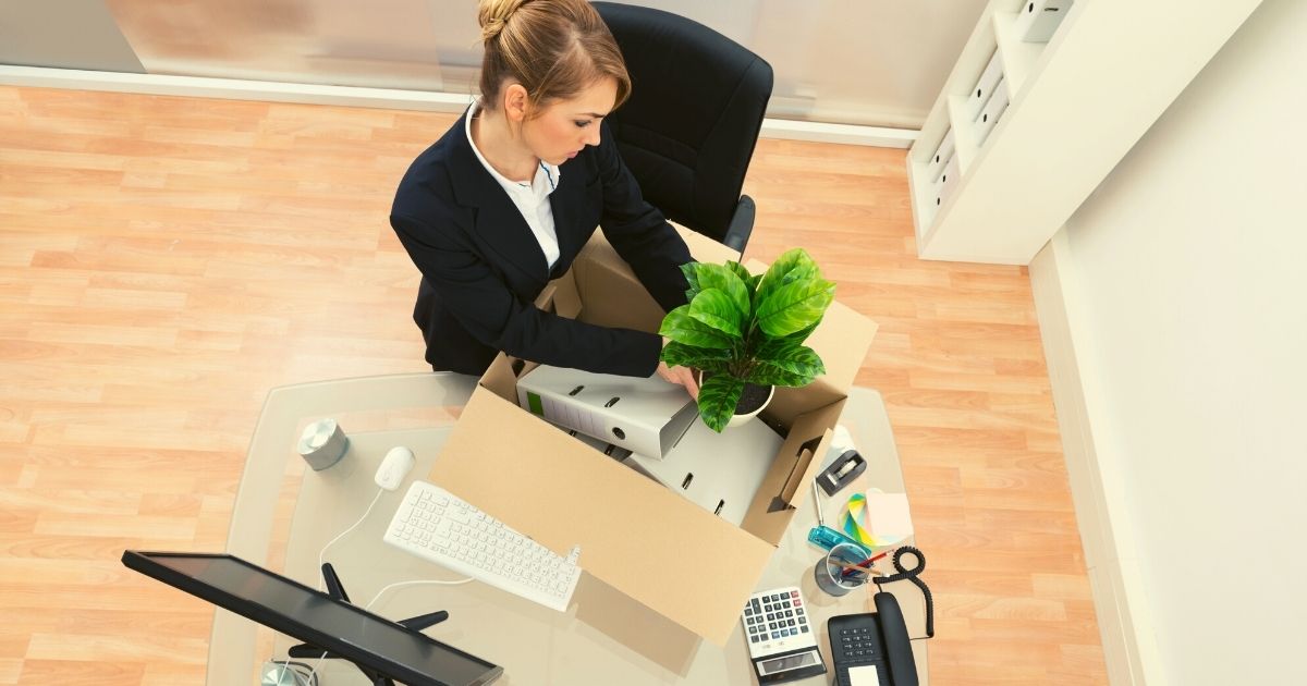 Women packing her stuff in office to finally leave