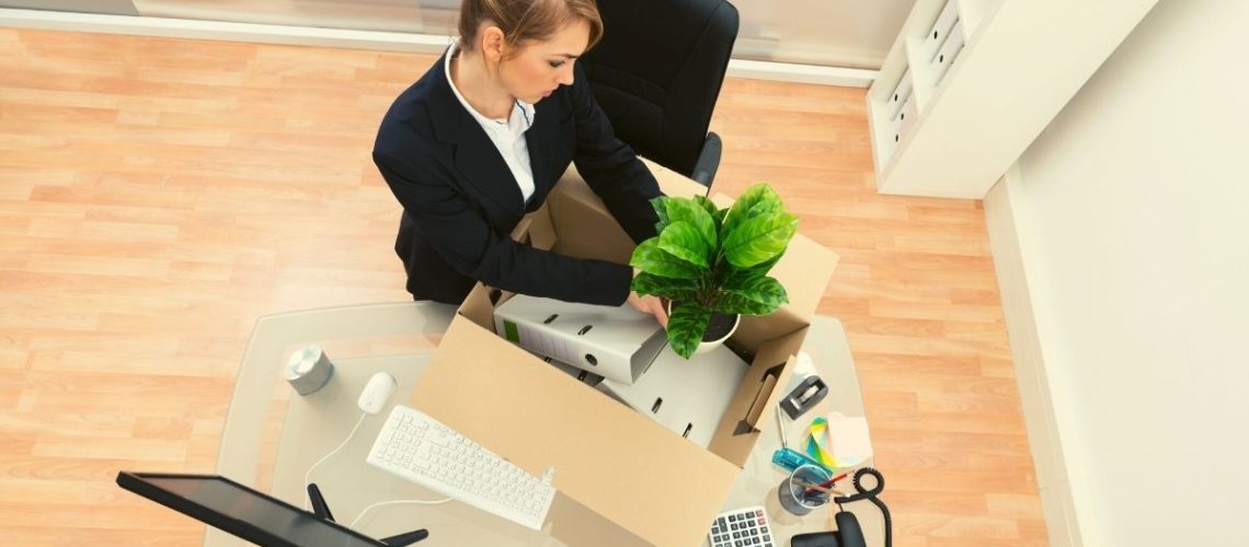 Women packing her stuff in office to finally leave
